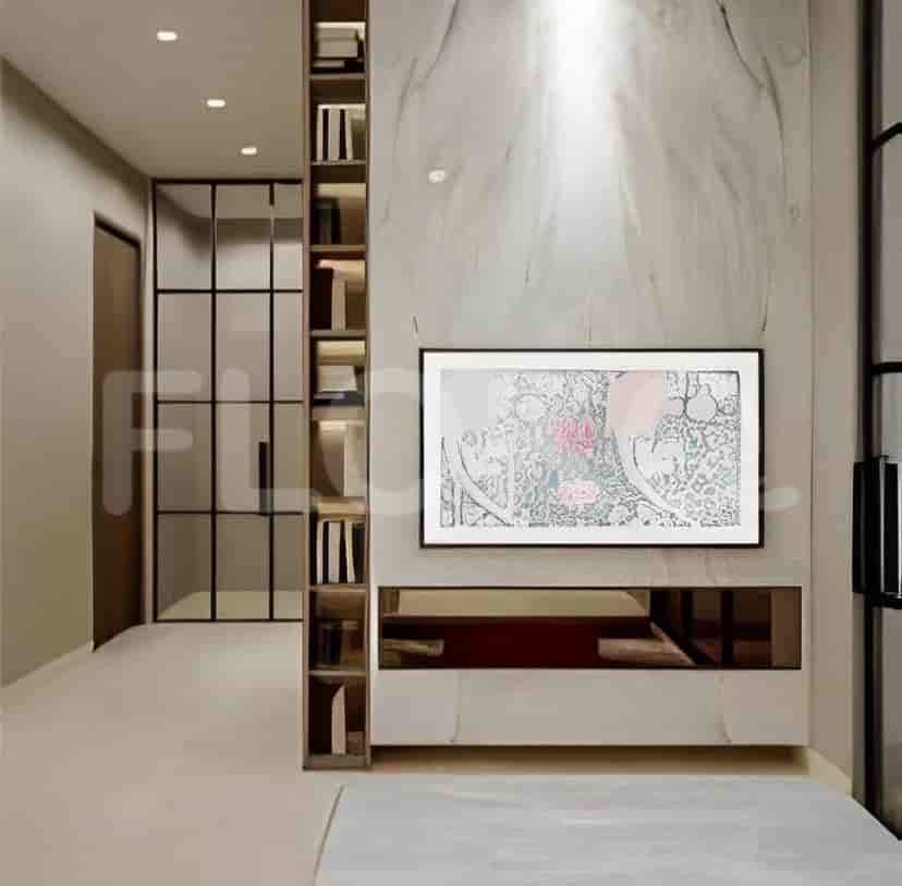 Bedroom area featuring a tall bookshelf and a TV mounted above a low cabinet.