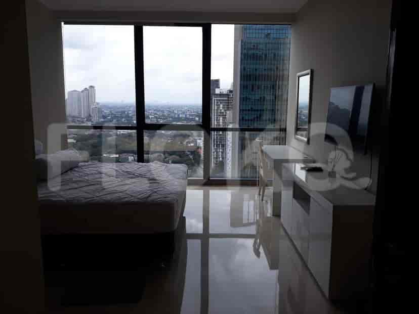 Bright bedroom with a double bed, a desk, and a city view.