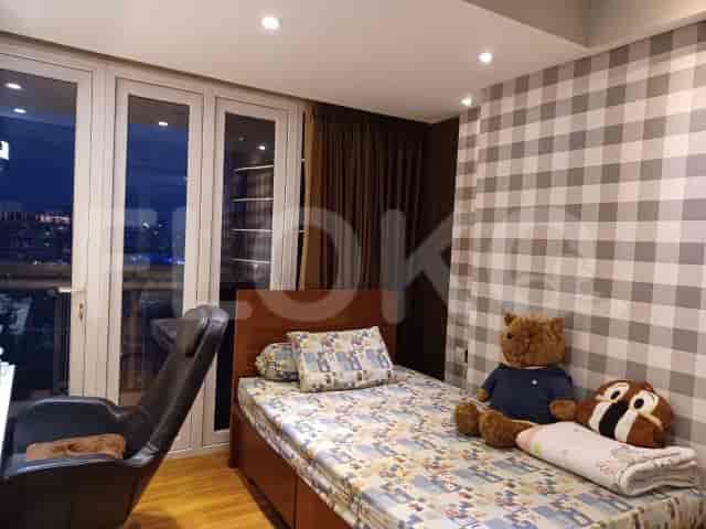 Bedroom with a single bed, a teddy bear, and checkered wallpaper.