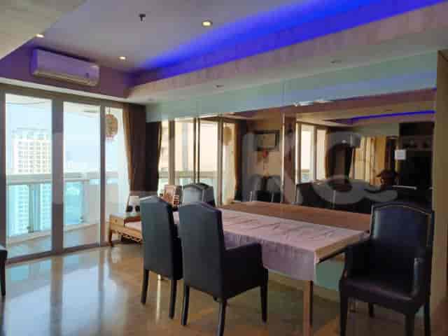 Dining area with a wooden table, chairs, and a large mirror.
