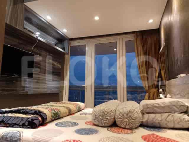 A bedroom with a double bed and a view.