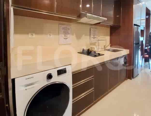 A compact and modern kitchen area with a washing machine.