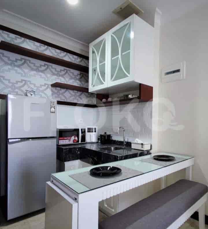 A compact, well-equipped kitchen with a dining table.