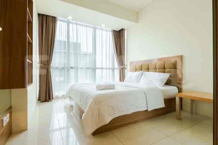 A cozy bedroom with a comfortable queen-sized bed and ample natural light.