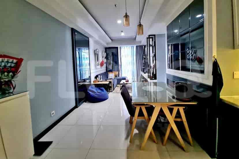 A well-lit dining and living area featuring modern furniture and decor.