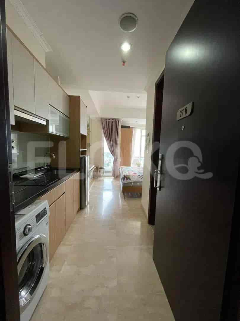A hallway leading to the bedrooms and kitchen, with an elegant and compact design.