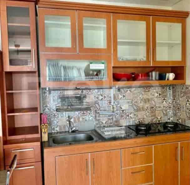 Kitchen featuring wooden cabinets, a sink, and a stovetop.
