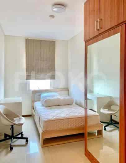Bedroom with a single bed, work desks, and a large mirror.