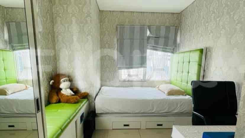Bedroom with a bed, study table, and an attached bathroom.