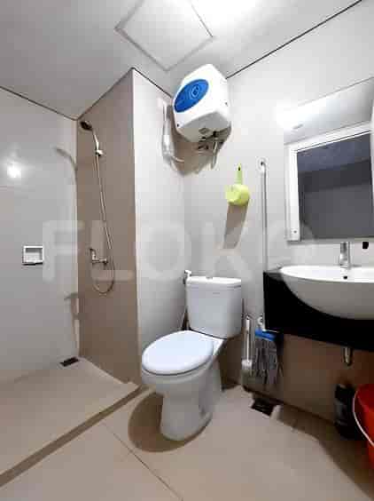 A bathroom with a toilet, sink, and shower.