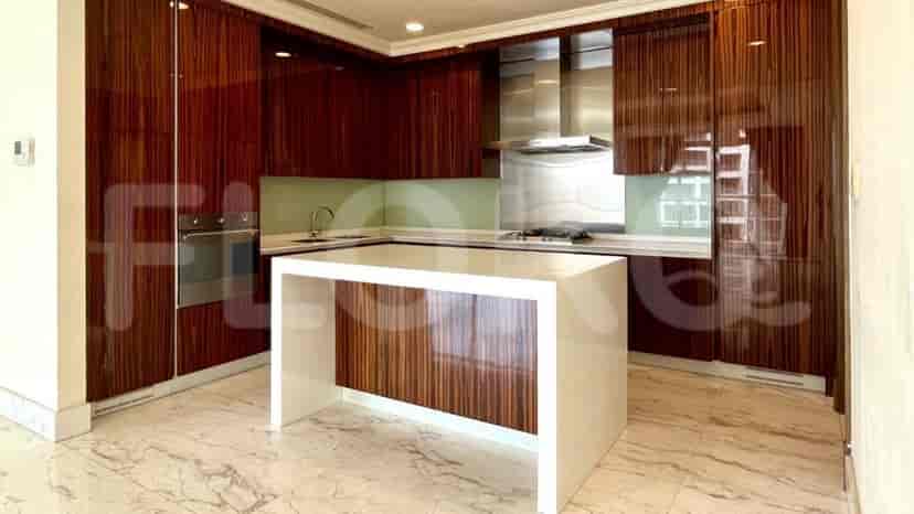 Modern kitchen with wooden cabinets, a white island, and marble flooring.