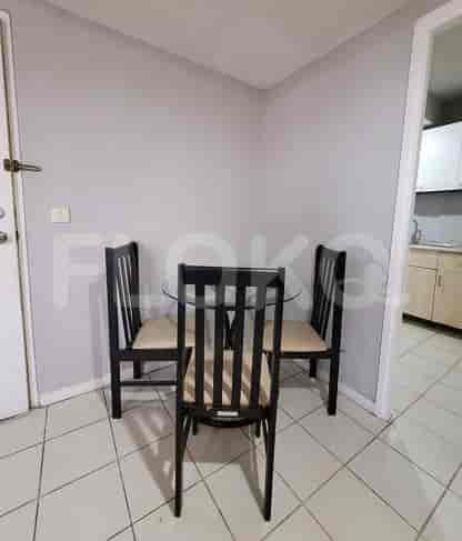 Dining area with a glass-top table and chairs.