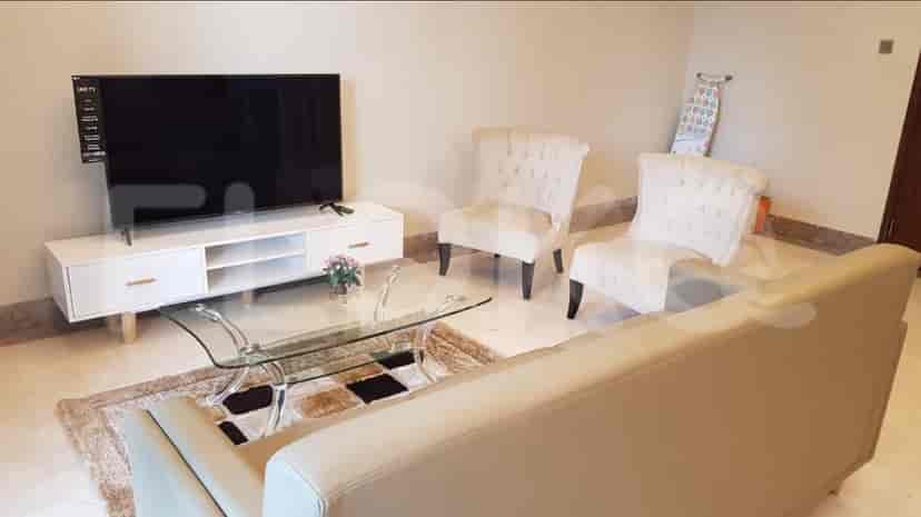 Living room featuring a TV, coffee table, armchairs and sofa.