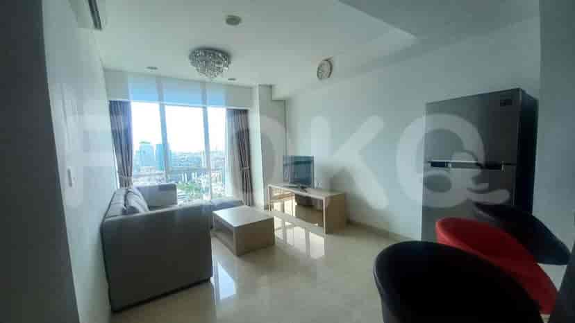 Living room with a sofa, TV, and kitchen island.