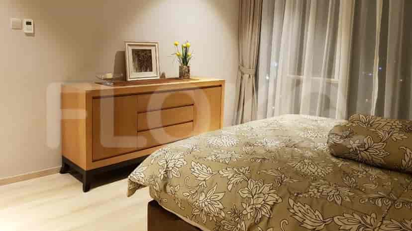 A guest bedroom featuring a sideboard and bed.