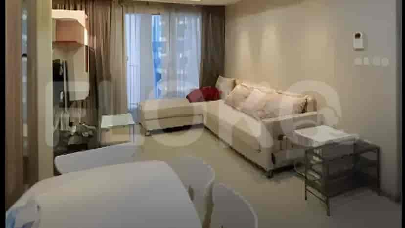 Living room with sofa, dining table, and balcony access.