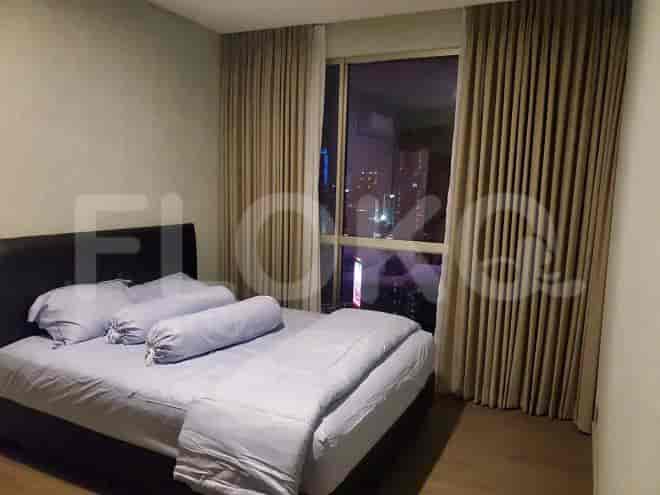 Bedroom featuring a large bed and a view of the city.