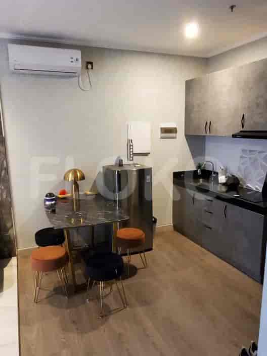 Compact kitchen and dining space with a table and stools.