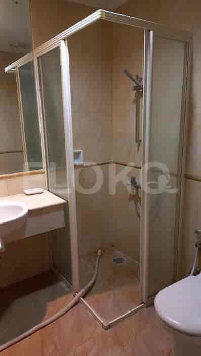 Bathroom with a shower stall, sink, and toilet.