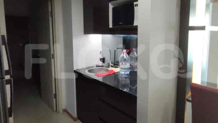 A small kitchenette with cabinets and a microwave.