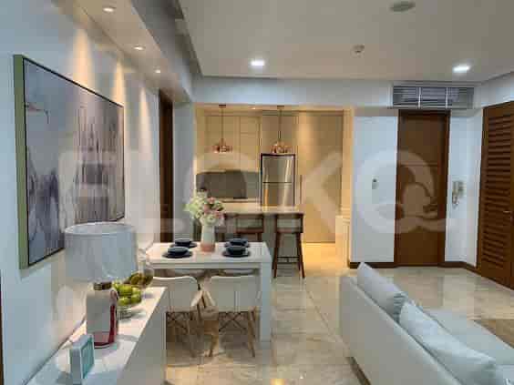 An open-concept living and dining area with an open kitchen, featuring modern fixtures and a dining set.