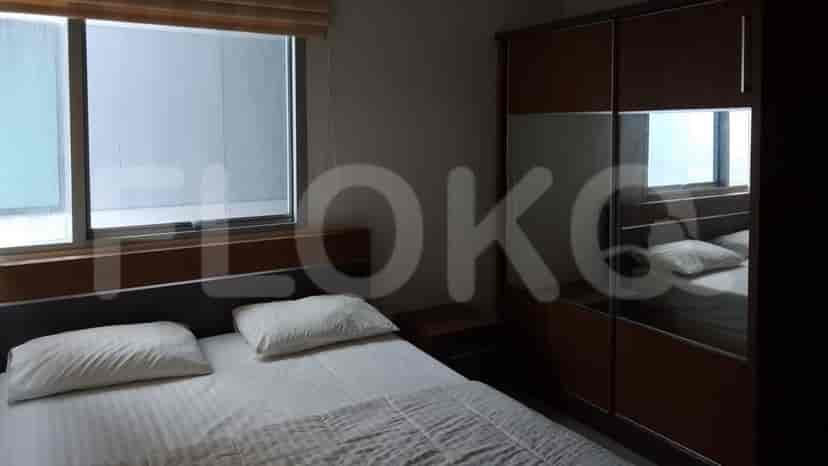 A cozy bedroom featuring a bed, window with blinds, and a closet.