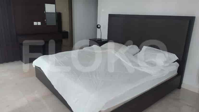 Bedroom with bed, side table and mirror.