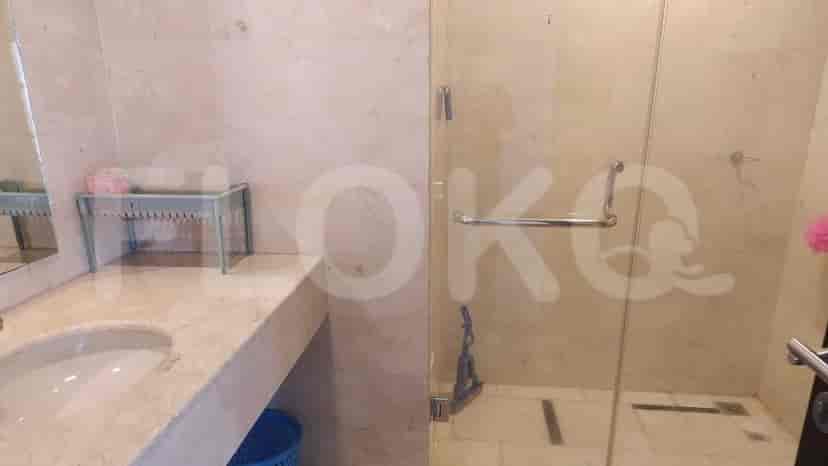 Modern bathroom with glass shower, sink, and toilet.