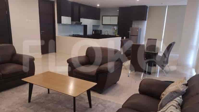 Open floor plan showing living room, dining area, and kitchen with modern appliances.