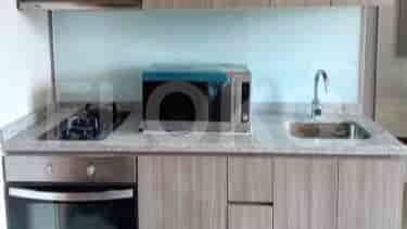 A modern kitchen with a microwave, stove, and sink.