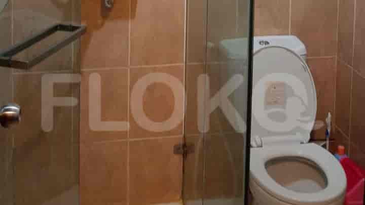 A bathroom with a toilet and shower.