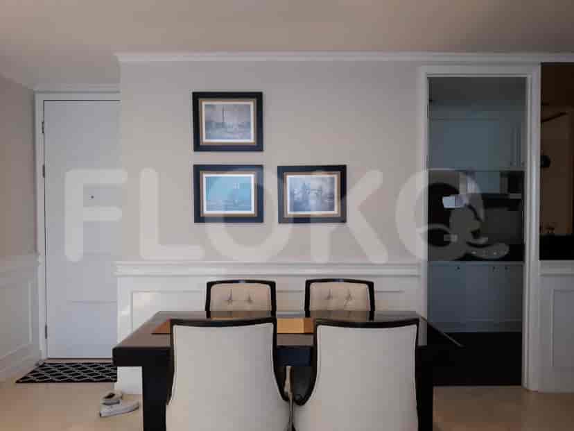 A dining area with artwork and a dining table.