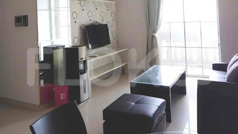 A modern living room with a TV, sofa, and coffee table.