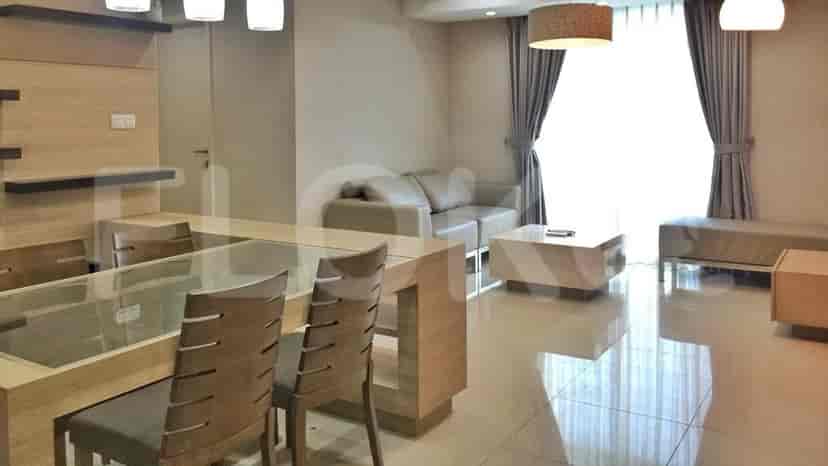 A dining area in a modern apartment with a dining table and chairs.
