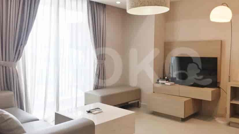 Living room with TV and a neutral color palette.