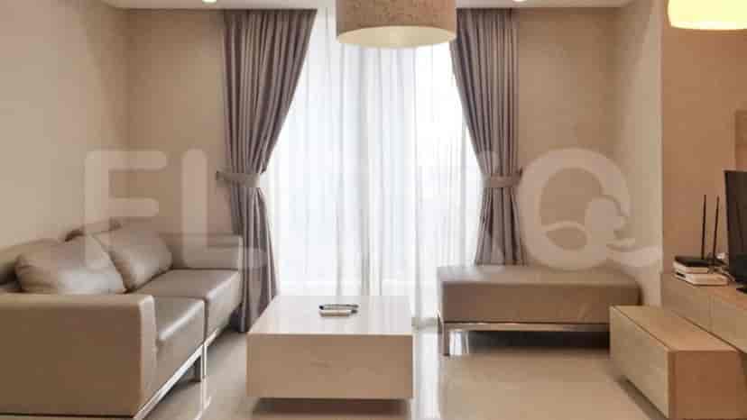 A modern living room with a grey sofa, marble coffee table, and large windows.