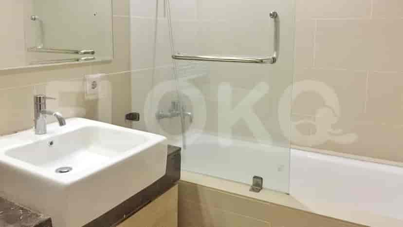 Modern bathroom with sink, bathtub, and glass shower enclosure.