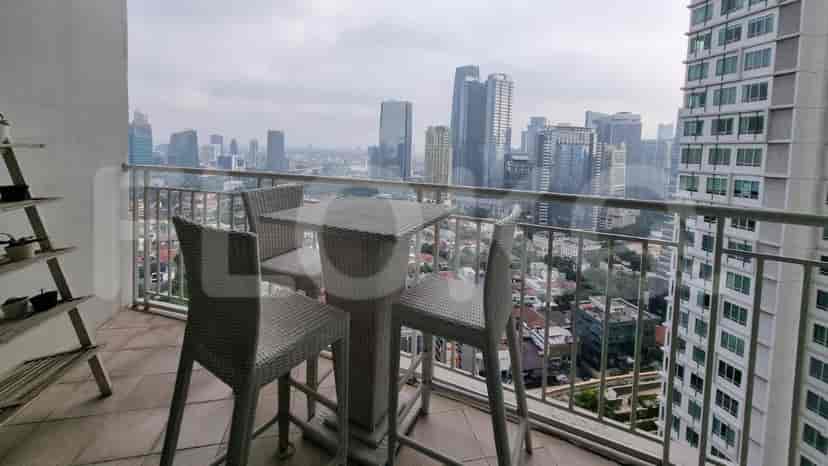 A balcony with a city view and outdoor furniture.