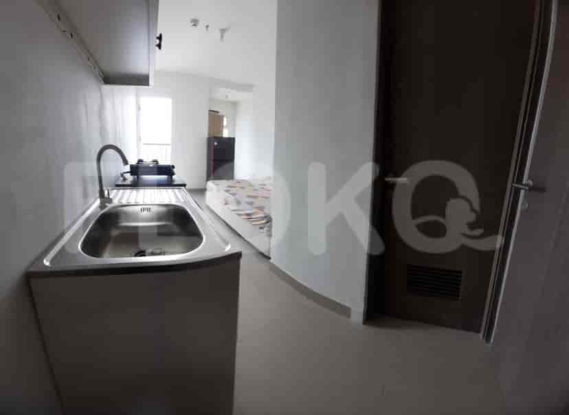 Close-up view of the kitchenette, showing the sink and a view to the rest of the apartment.
