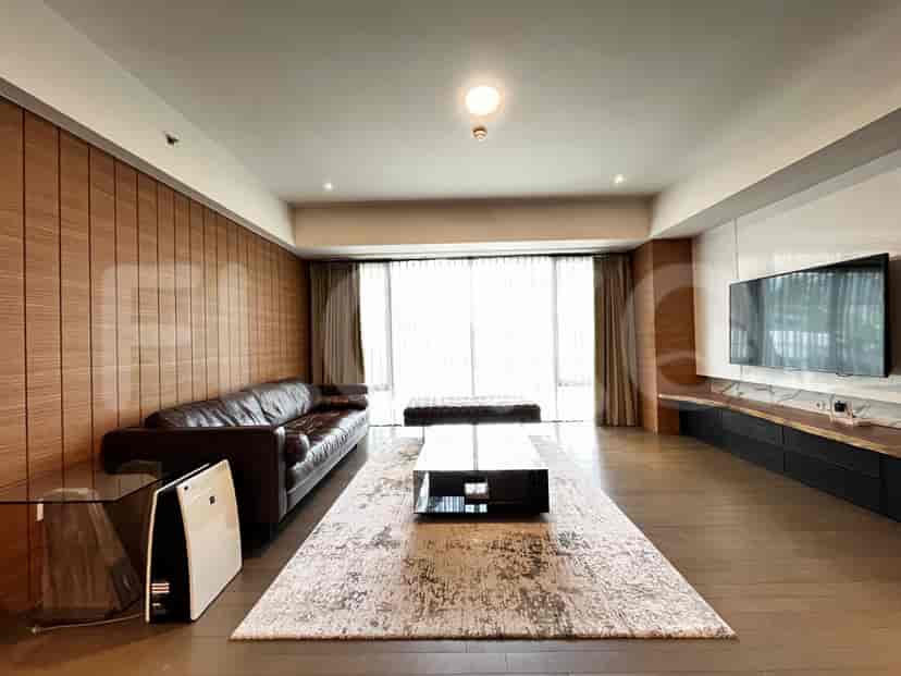 Spacious living room with leather sofa, coffee table, and a modern aesthetic.