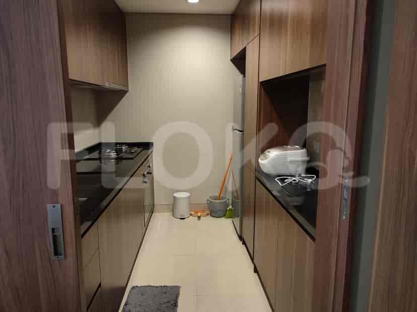 A kitchen with wooden cabinets and a stove.