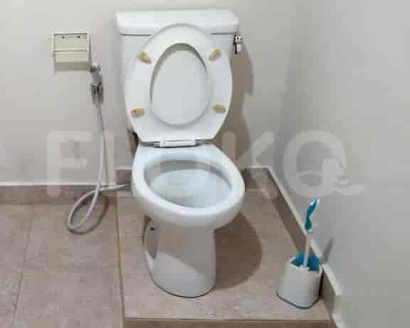 A bathroom with a toilet and other sanitary appliances.