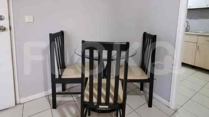 A dining area with a glass table and chairs.