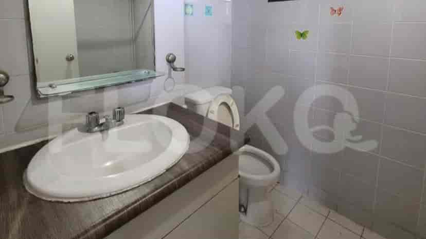 A bathroom with a sink, toilet, and mirror.