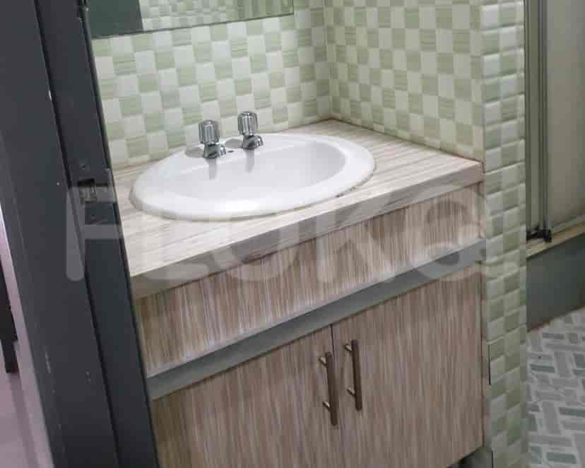 Bathroom with a sink and checkered tiles.
