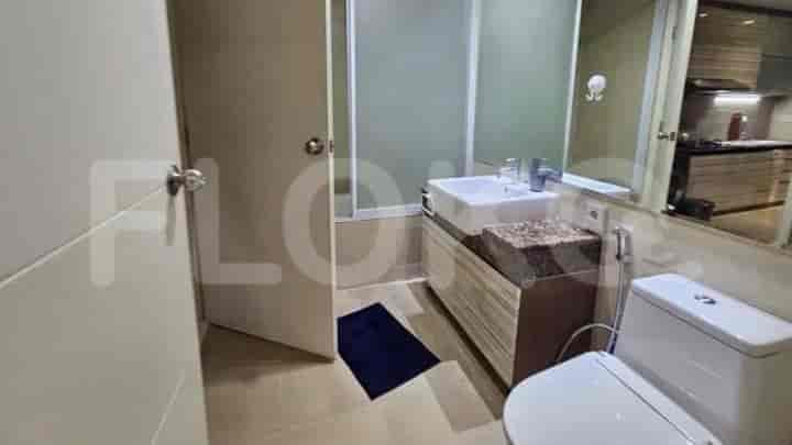Bathroom with a sink, toilet, and shower stall.