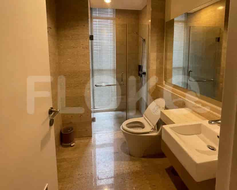 A modern bathroom with a toilet, a sink and shower.