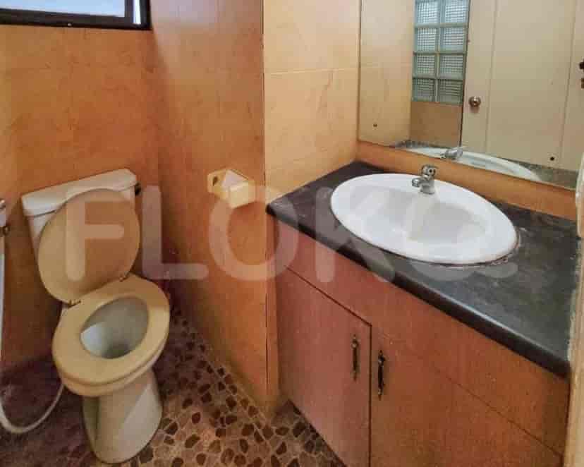 Bathroom with toilet, sink, and mirror.