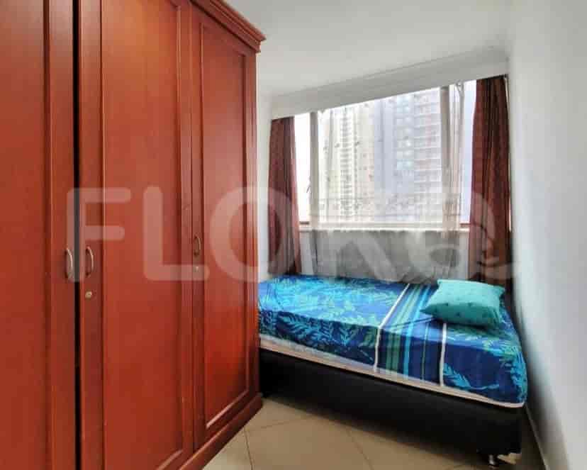 Small bedroom with a single bed, wardrobe, and window.
