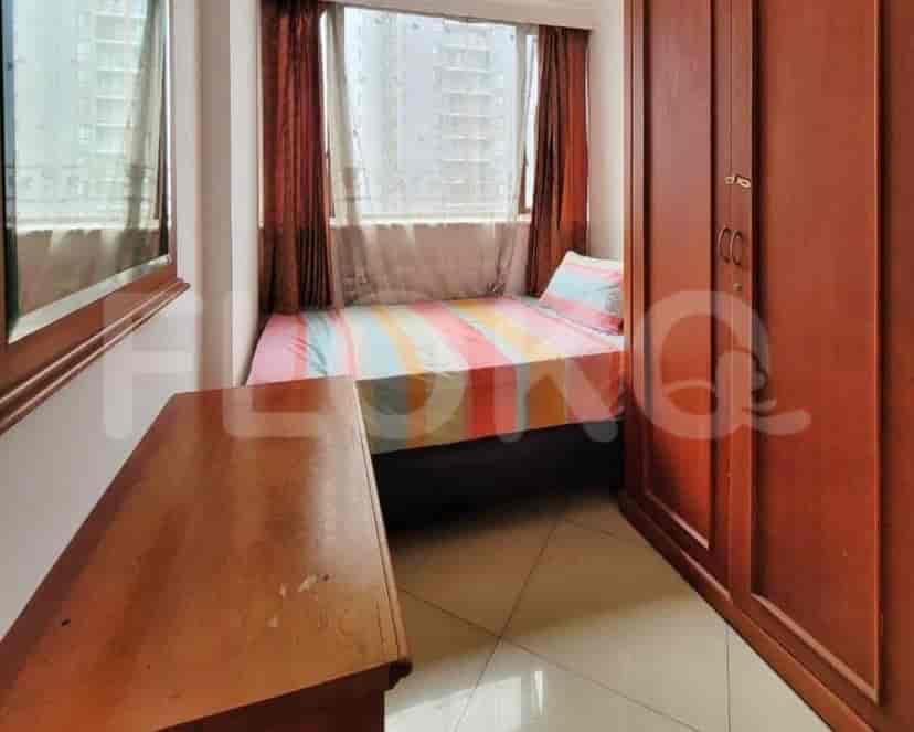 Small bedroom with a single bed, wardrobe, and mirror.
